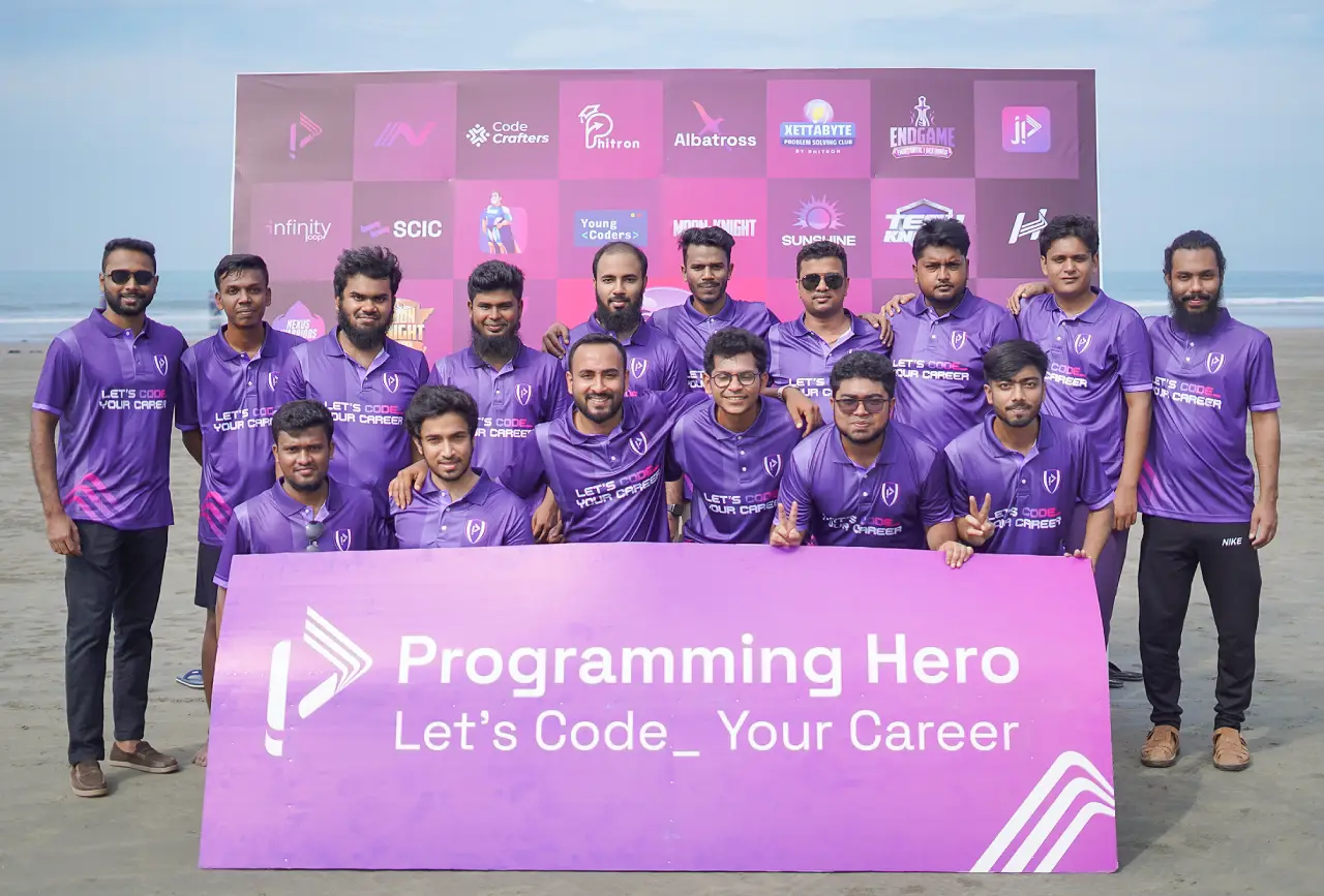 Programming Hero team in purple jerseys behind a Let's Code Your Career banner