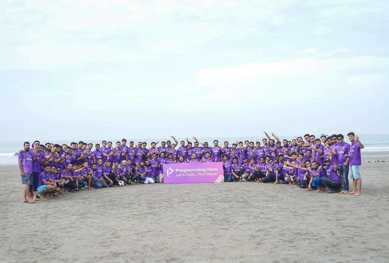 The full Programming Hero team gathered on the beach in purple jerseys