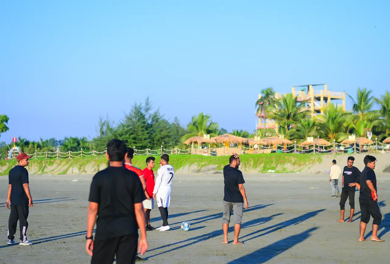 Team members playing on the beach during a Programming Hero retreat
