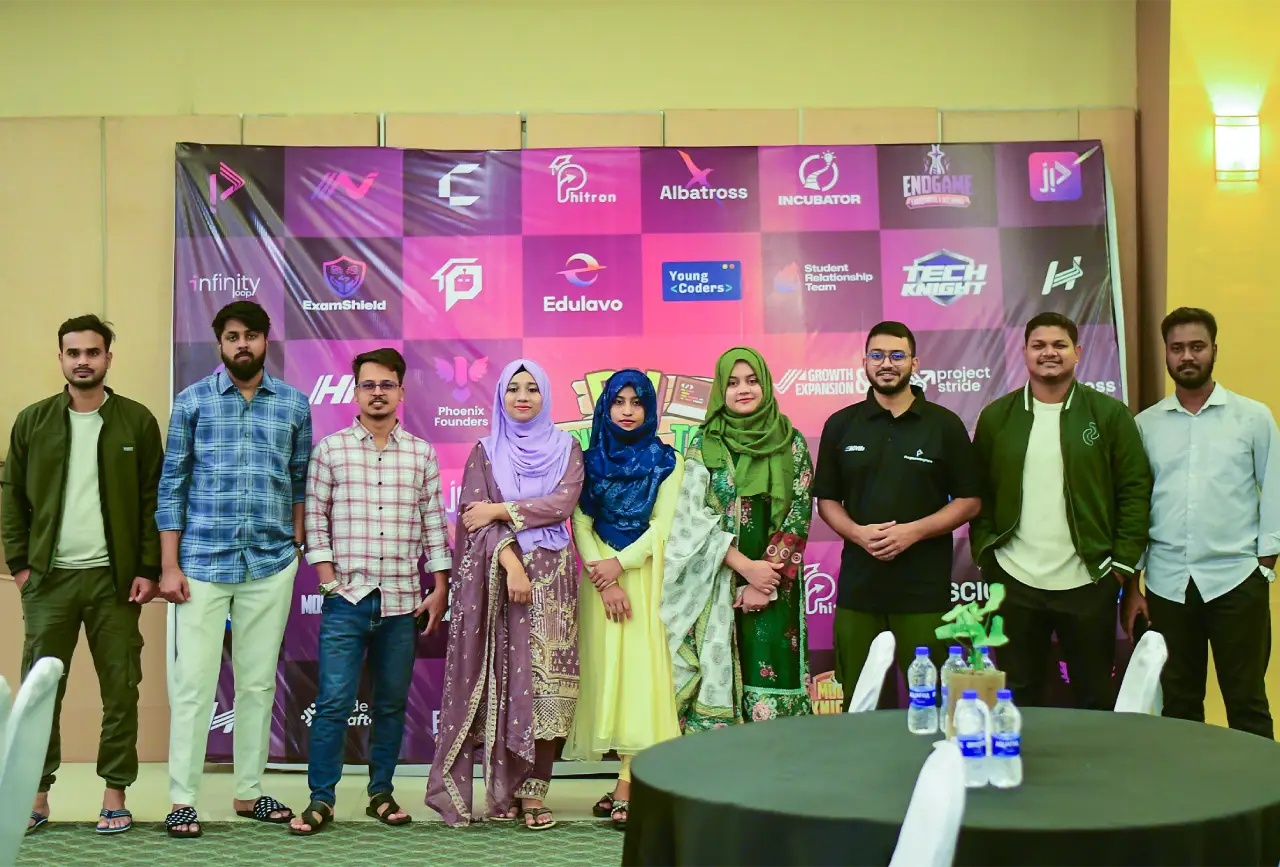 Programming Hero team members in front of an event backdrop