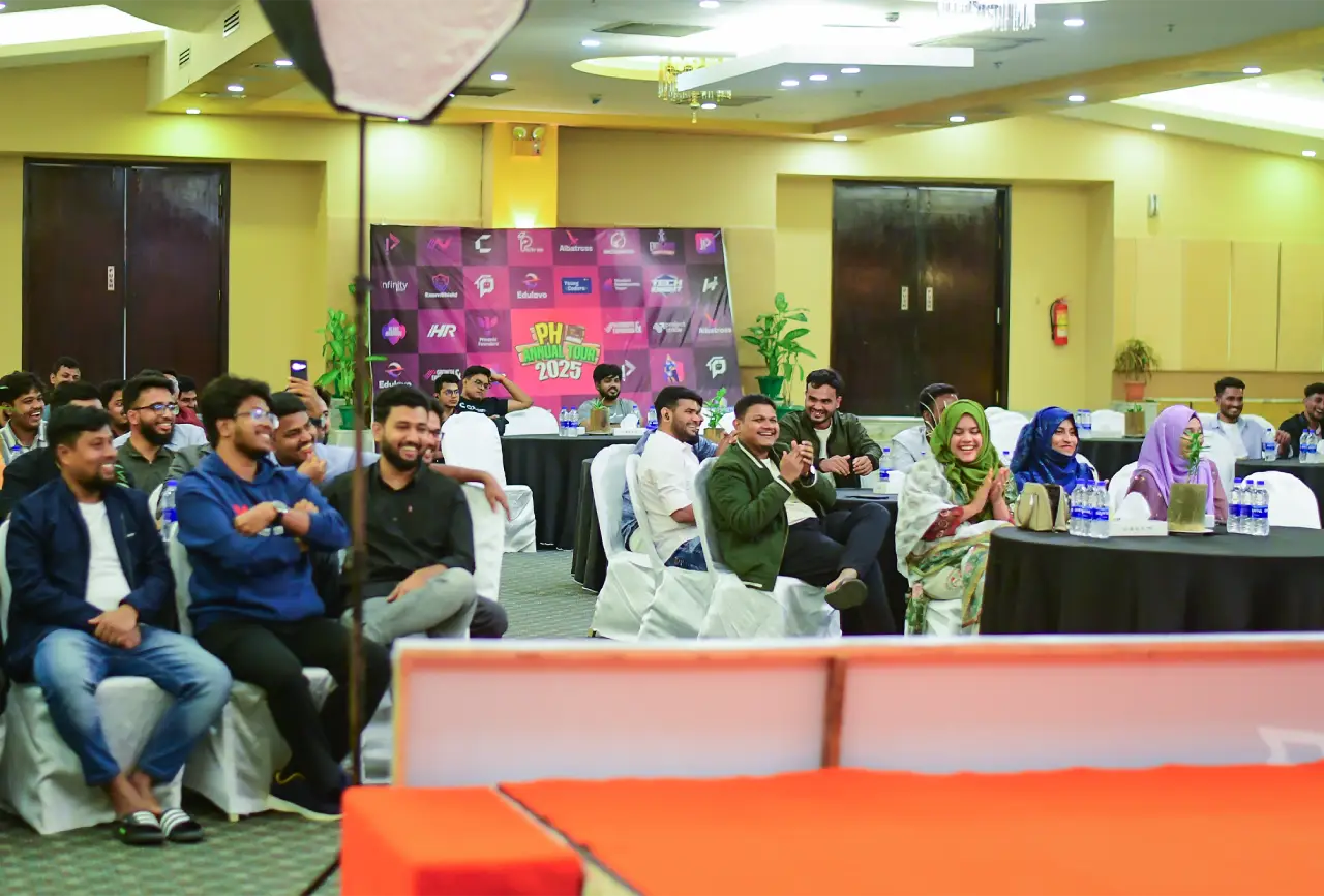 Team members seated at tables during an indoor Programming Hero event